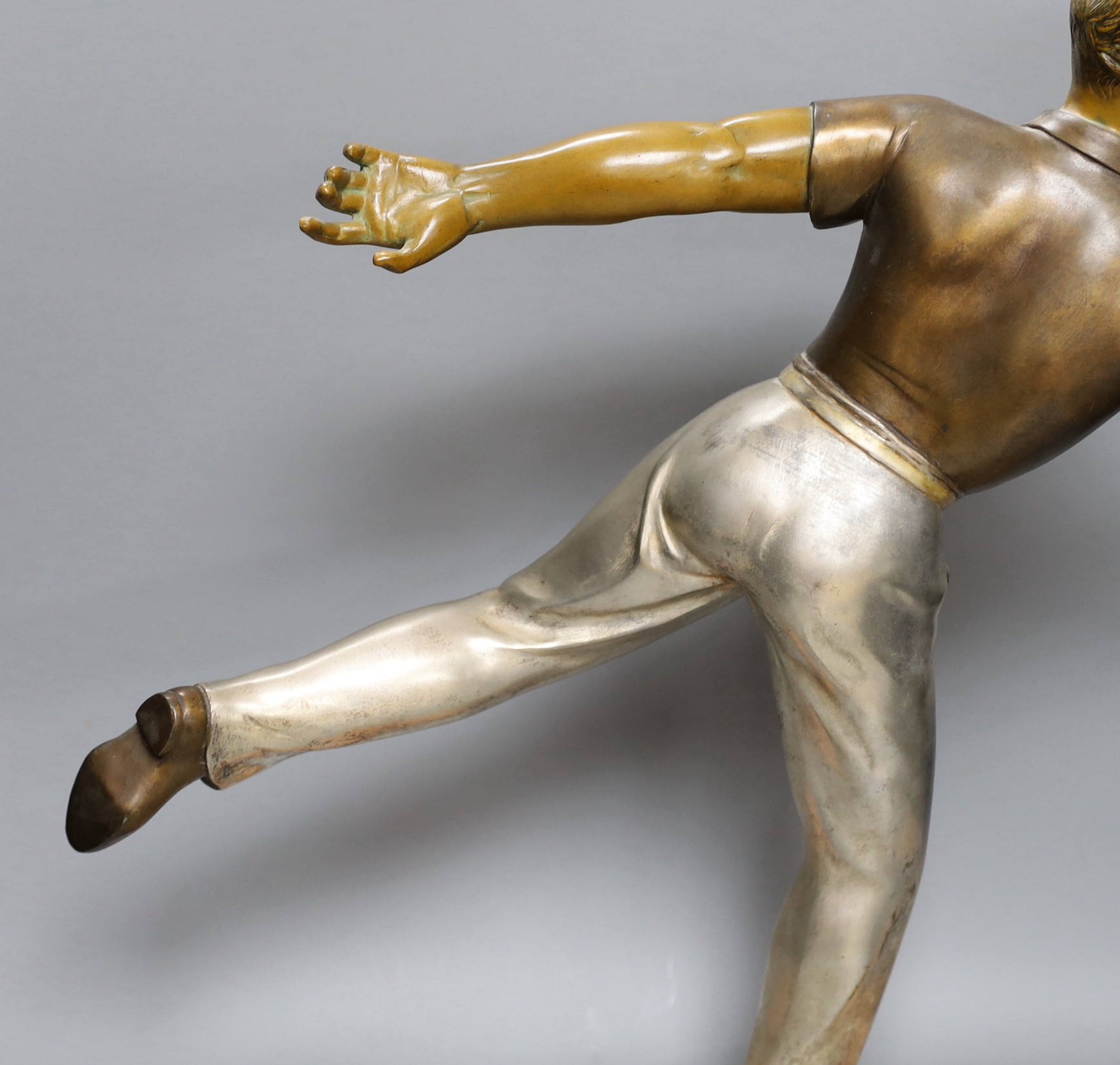 An Art Deco style bronzed and silvered spelter figure of a boule player, on marble plinth, height 51cm